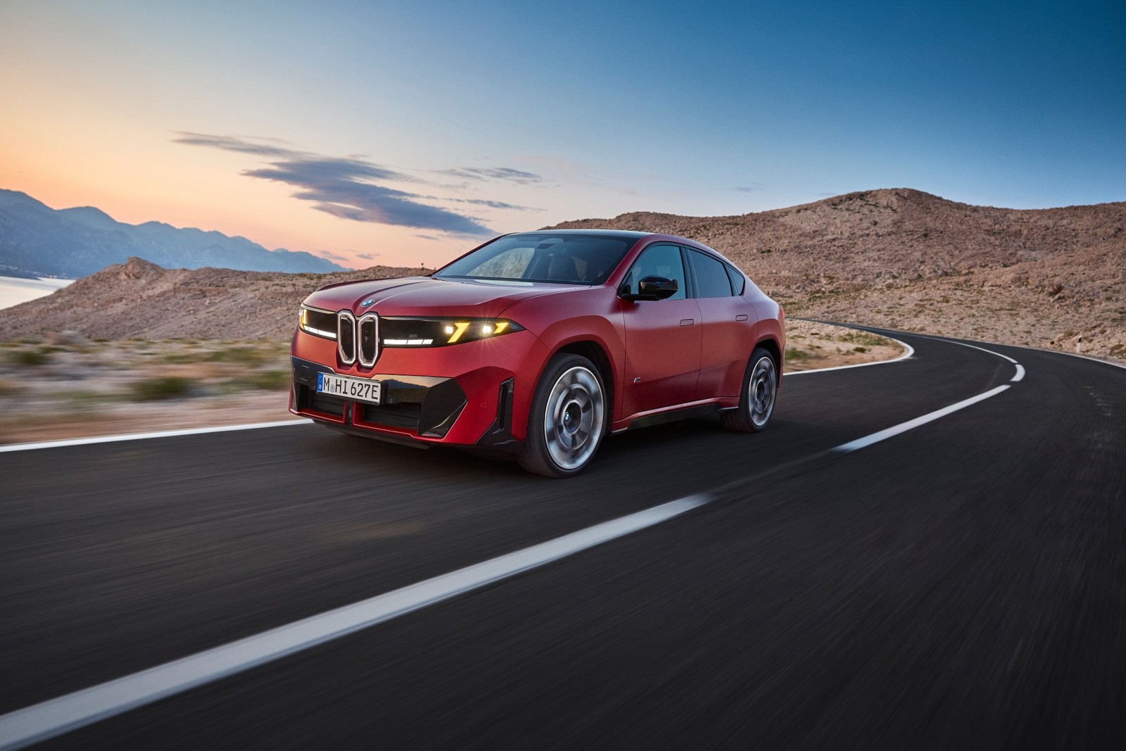 BMW iX4 M60 xDrive on a coastal road